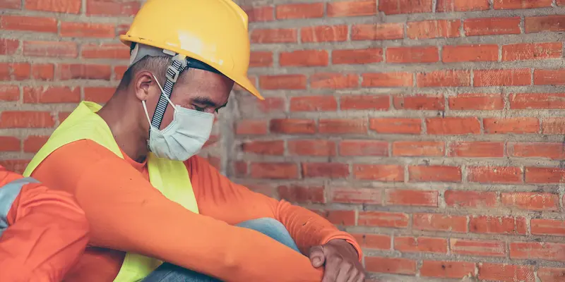 Male looking stressed wearing yellow hard hat.webp (31 KB)